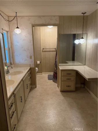 a spacious bathroom with a double vanity sink and a mirror