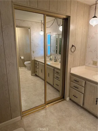 a spacious bathroom with a mirror sink and double
