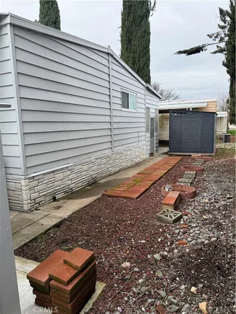 a backyard of a house with barbeque oven