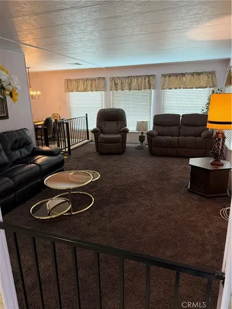 a living room with furniture a rug and a window