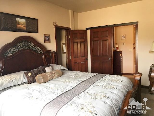 59373 Hop Patch Spring Road Mountain Center, CA 92561 - Photo 15 of 41 a bedroom with a bed and a closet