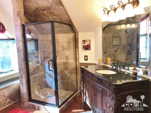 59373 Hop Patch Spring Road Mountain Center, CA 92561 - Photo 22 of 41 a bathroom with a granite countertop sink a mirror and shower