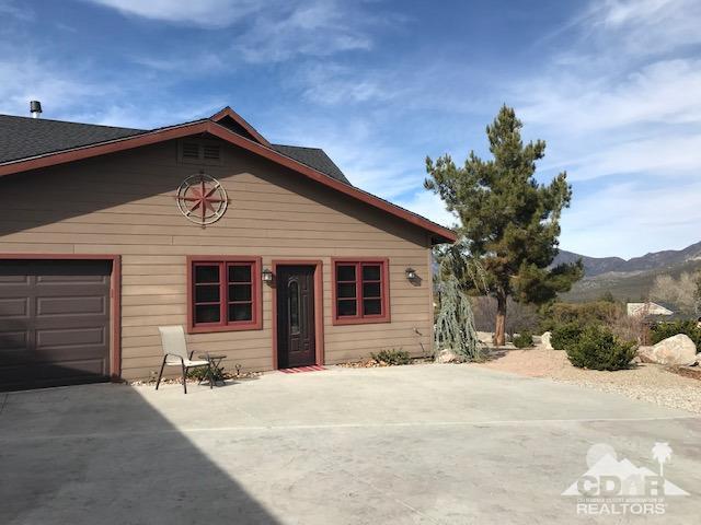 59373 Hop Patch Spring Road Mountain Center, CA 92561 - Photo 23 of 41 a front view of a house with a yard and garage