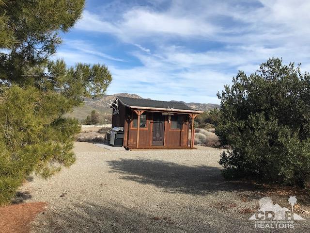 59373 Hop Patch Spring Road Mountain Center, CA 92561 - Photo 31 of 41 a front view of a house with a yard and garage
