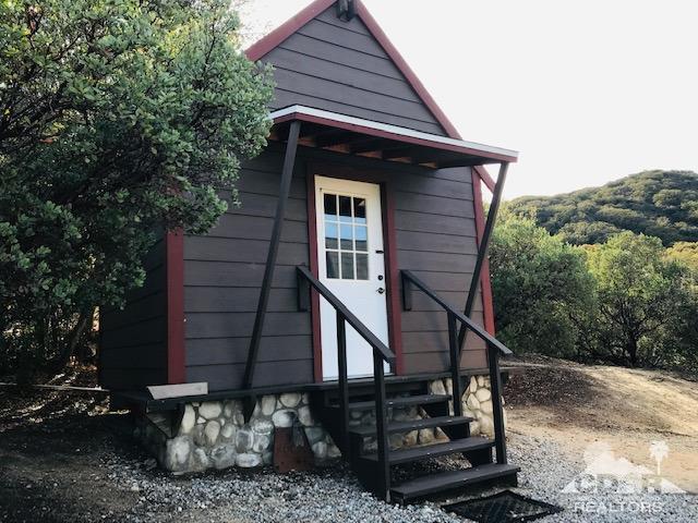 59373 Hop Patch Spring Road Mountain Center, CA 92561 - Photo 37 of 41 a view of a small house with a small deck