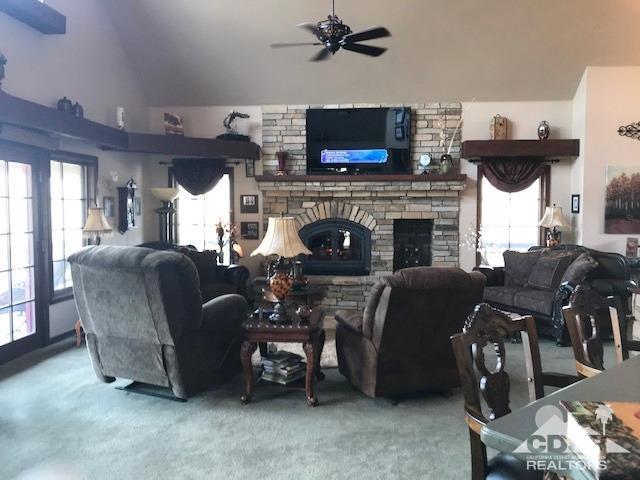 59373 Hop Patch Spring Road Mountain Center, CA 92561 - Photo 5 of 41 a living room with furniture a fireplace and a flat screen tv