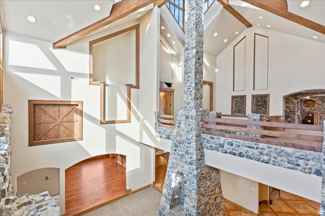 246 Woods Creek Road Morgan, UT 84050 - Photo 47 of 69 Two-story stone fireplace, cathedral ceilings, exposed wood beams, skylights, and a stone and wood-finish railing