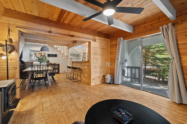 a dining room with furniture and a floor to ceiling window