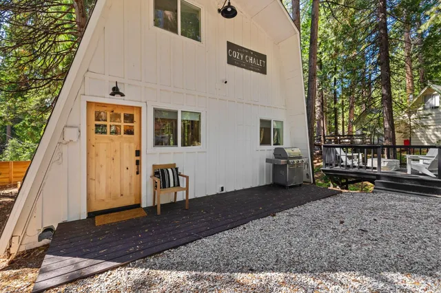 a view of a house with backyard and sitting area