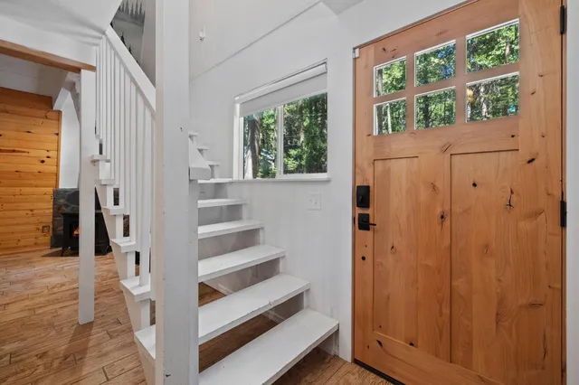 a view of walk in closet with wooden floor and windows