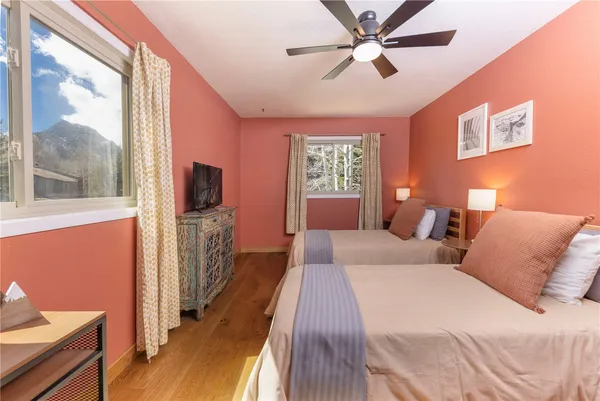 a bedroom with a large bed and a window