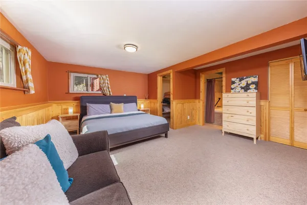a bedroom with a bed and dresser