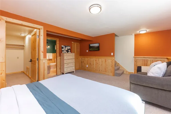 a bedroom with a bed and a couch