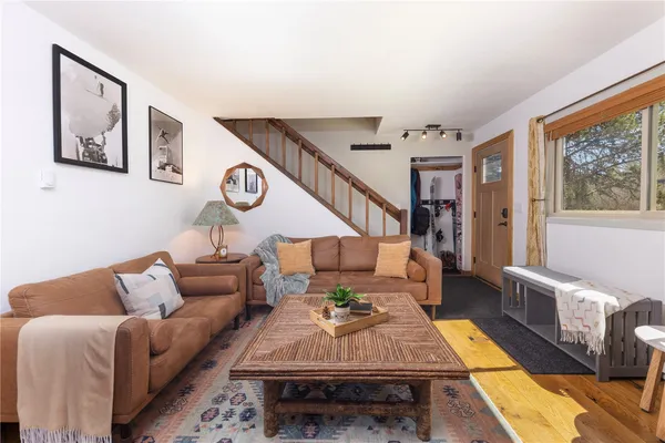 a living room with furniture and wooden floor