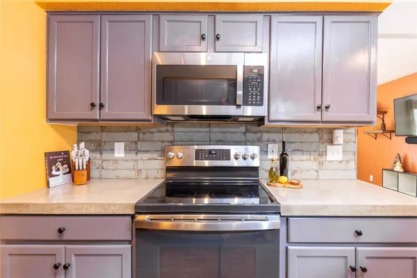 a kitchen with a stove and a microwave