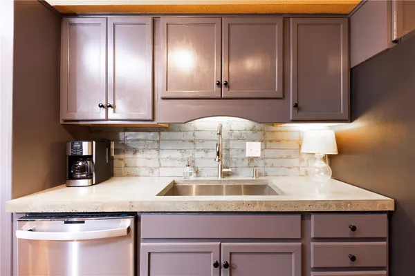 a kitchen with a sink and cabinets