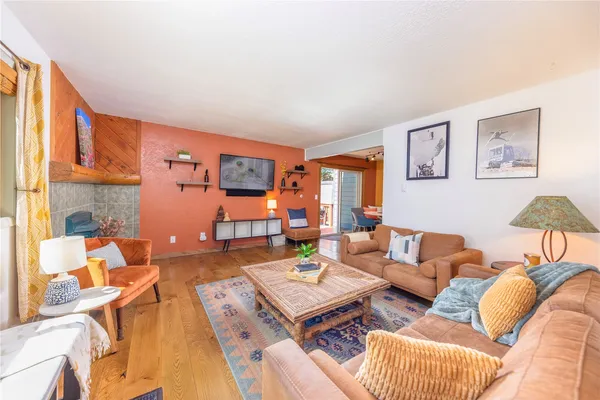 a living room with furniture and a floor to ceiling window