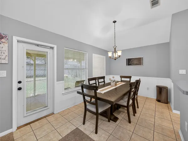 a dining room with furniture and window