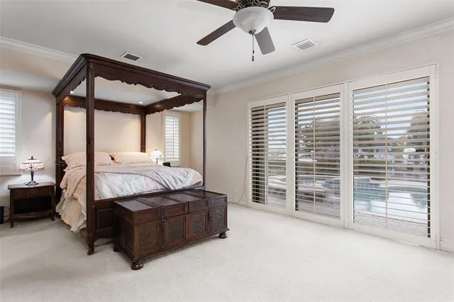 a spacious bedroom with a bed and a chandelier
