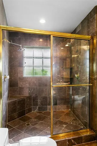 a bathroom with a glass shower door
