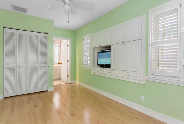 a view of empty room with window and cabinet
