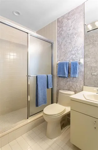 a bathroom with a toilet a sink and a shower