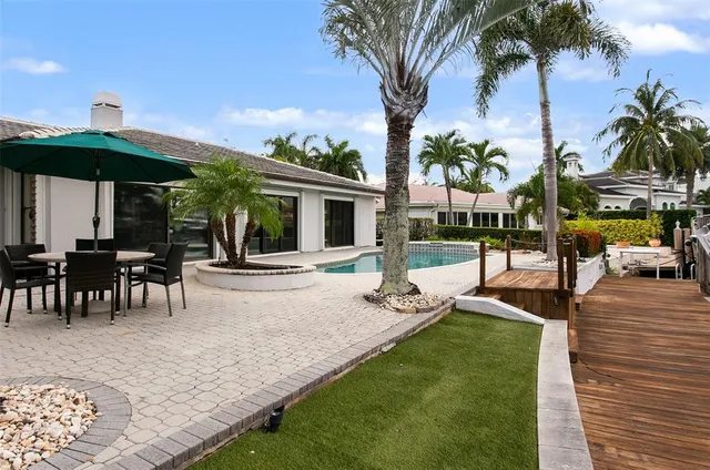 a view of a house with backyard porch and sitting area