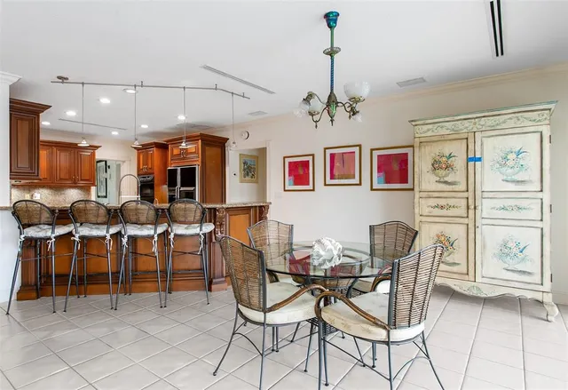 a view of a dining room with furniture and chandelier