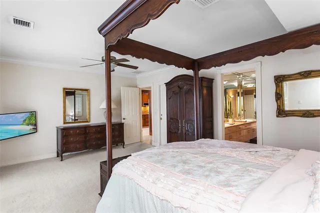 a bedroom with a bed dresser and mirror