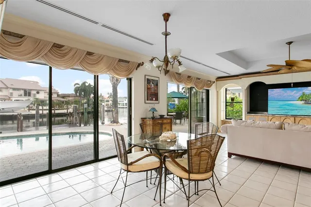 a dining room with furniture a chandelier and fireplace