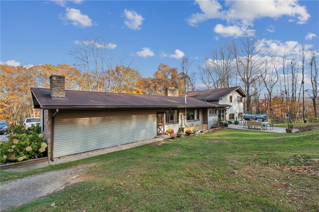 146 Jacobs Drive Boswell, PA 15531 - Photo 2 of 35 a front view of a house with a garden and plants