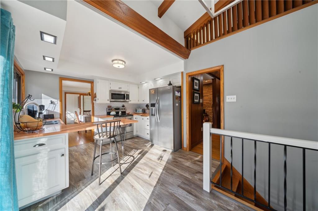 146 Jacobs Drive Boswell, PA 15531 - Photo 5 of 35 a view of a living room and kitchen with furniture wooden floor and window