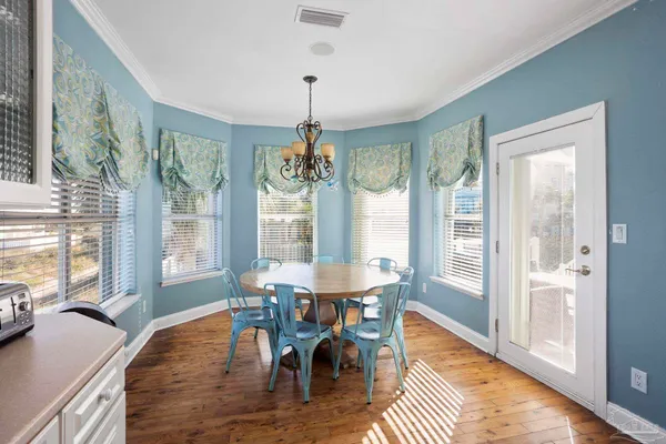 a bedroom with a bed chandelier and a window