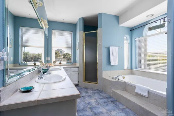 a bathroom with a granite countertop toilet sink and mirror