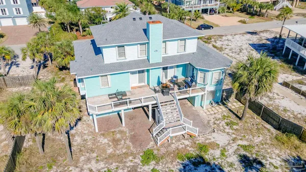 an aerial view of a house with a yard and potted plants