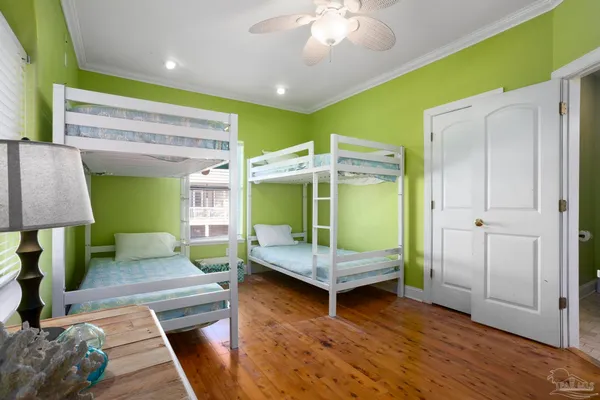 a bedroom with two beds and a large window