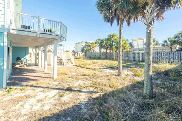 a kitchen with stainless steel appliances granite countertop a stove top oven a sink dishwasher a dining table and chairs with wooden floor