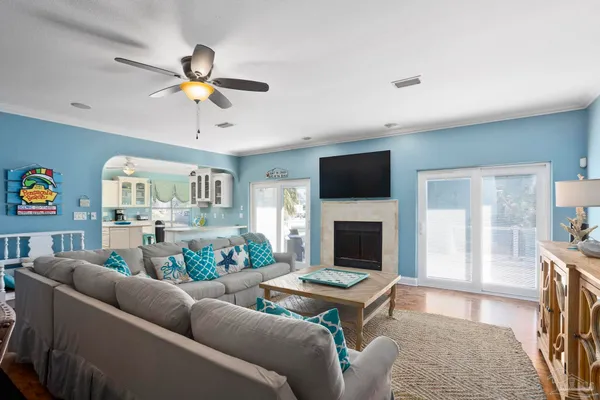 a living room with furniture a fireplace and a flat screen tv