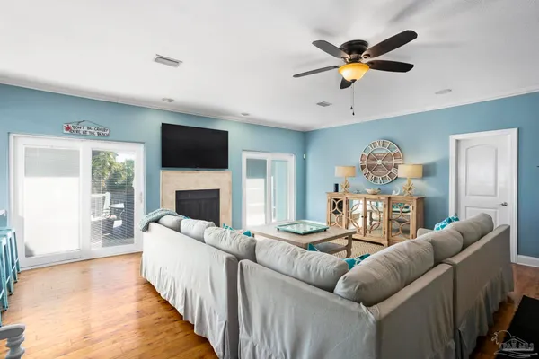 a living room with furniture a fireplace and a flat screen tv