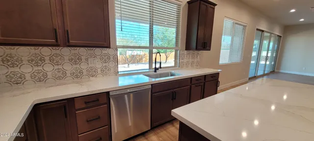 a kitchen with a sink cabinets and window