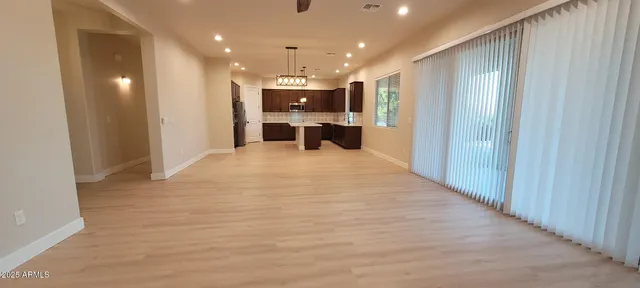 a view of an empty room with kitchen