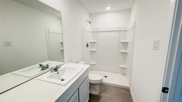 a bathroom with a sink toilet tub and shower