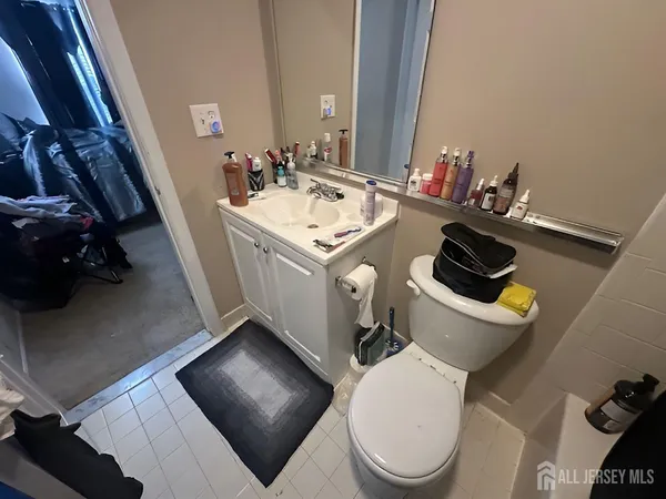 a bedroom with a bed and a flat tv screen on dresser