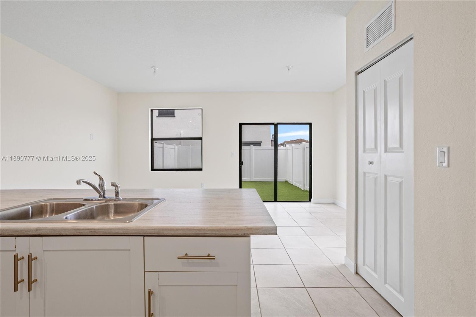 3411 West 112th Terrace Hialeah, FL 33018 - Photo 13 of 42 a hallway with a sink and mirror
