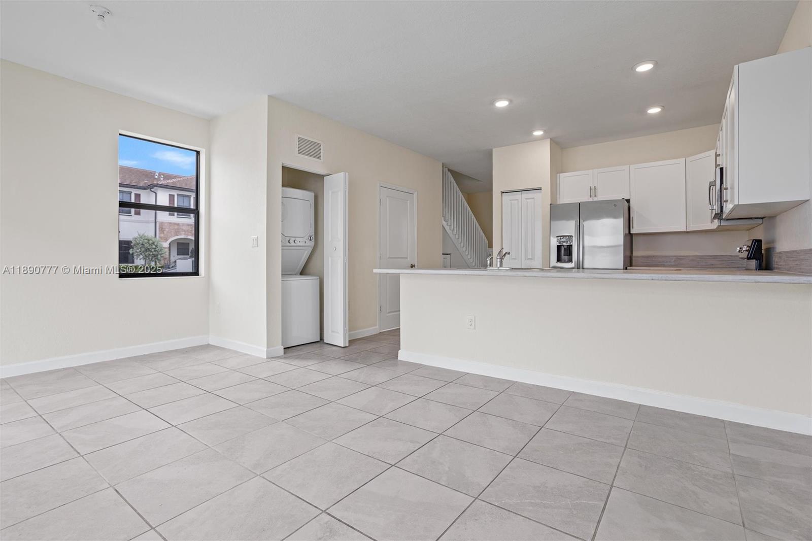 3411 West 112th Terrace Hialeah, FL 33018 - Photo 27 of 42 a view of a kitchen with a sink and dishwasher a refrigerator with white cabinets