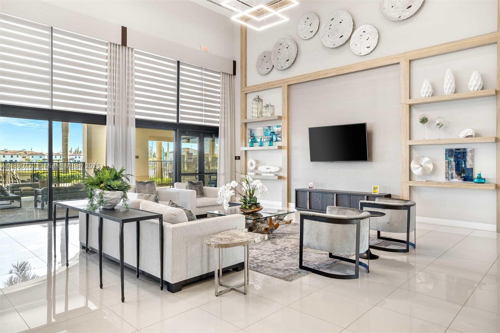 3411 West 112th Terrace Hialeah, FL 33018 - Photo 41 of 42 a living room with furniture a flat screen tv and a large window