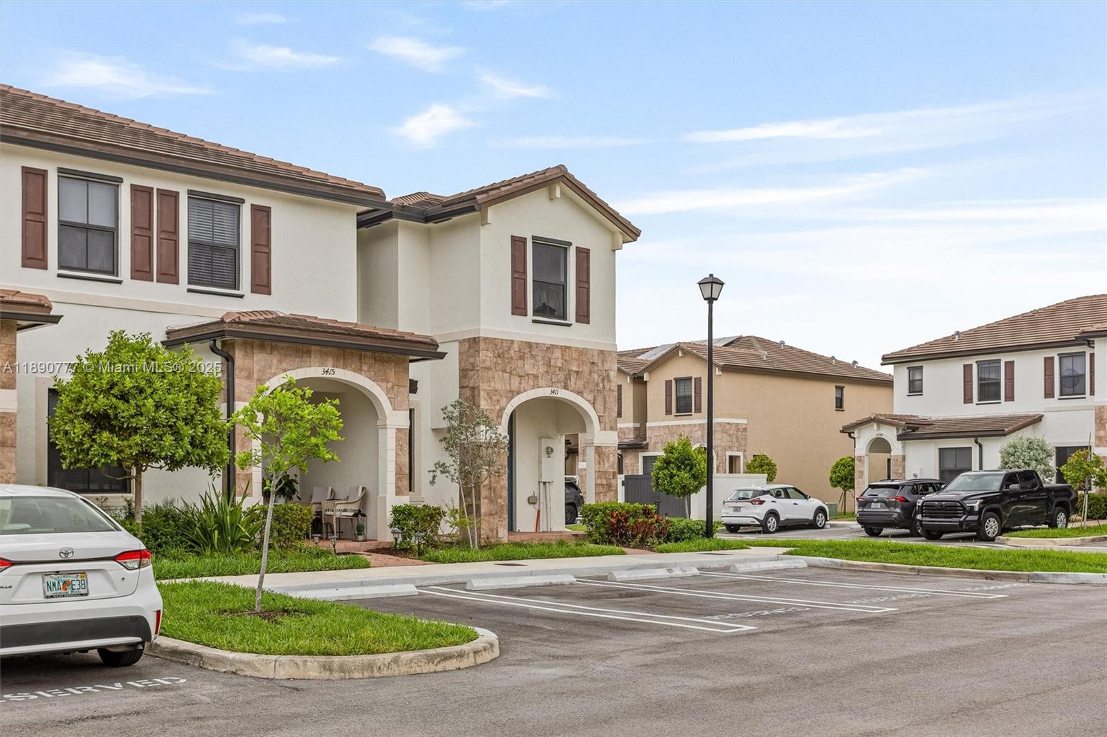 3411 West 112th Terrace Hialeah, FL 33018 - Photo 5 of 42 a front view of a house with a yard and garage