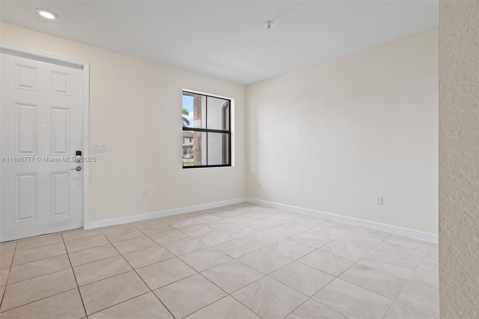 3411 West 112th Terrace Hialeah, FL 33018 - Photo 8 of 42 an empty room with windows