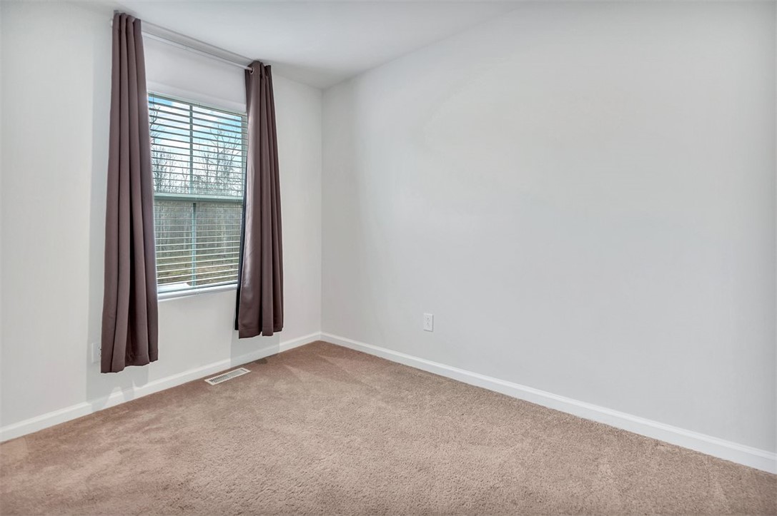150 Queens Mill Court Pendleton, SC 29670 - Photo 13 of 37 This inviting bedroom offers serene outdoor views through a large window, perfect for peaceful living.