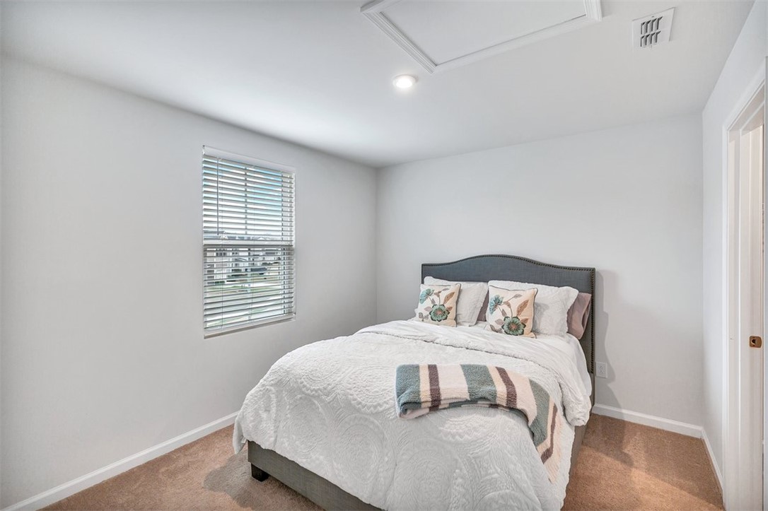 150 Queens Mill Court Pendleton, SC 29670 - Photo 21 of 37 This cozy bedroom features warm carpeting and a sunlit window, offering a serene personal retreat.